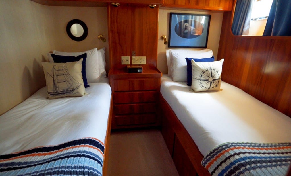 two beds and a nightstand in the Sockeye Suite. Nautical themed decor